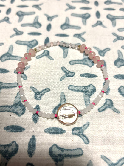 Handmade beaded anklet featuring a lustrous freshwater pearl centerpiece, surrounded by a playful mix of Czech beads, glass beads, soft rose quartz gemstones, and delicate pearls. Finished with 14k gold-filled details for a luxe coastal touch. Perfect for beach-inspired jewelry lovers, this anklet adds a splash of color and elegance to your summer style. Lightweight, feminine, and ideal for layering or wearing solo on sandy shores and sunny getaways.